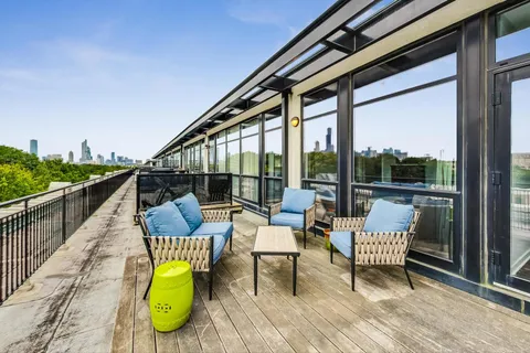 a view of roof deck with seating space and wooden floor