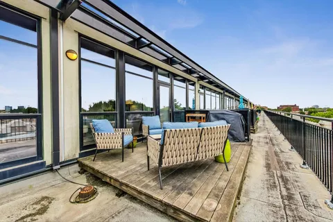 a balcony view with a couch and wooden floor