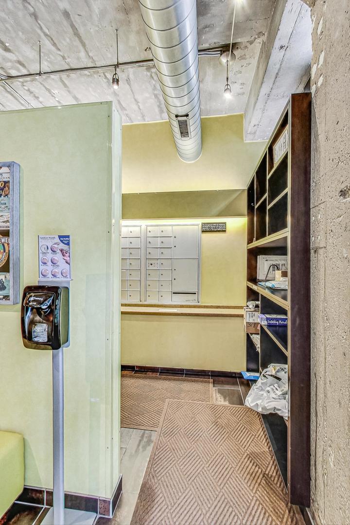 1111 West 14th Place, Unit 328 Chicago, IL 60608 - Photo 9 of 49 a bedroom with a bed and a window