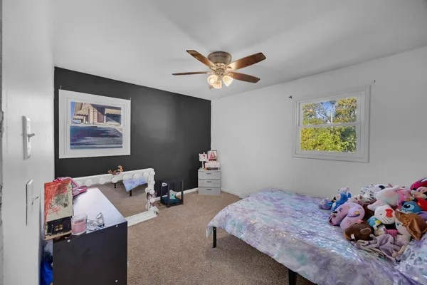 a bedroom with bed and furniture