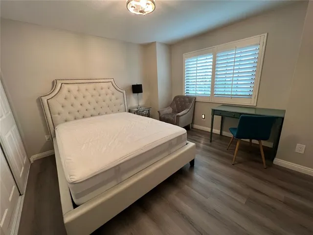 a bed sitting in a bedroom next to a window