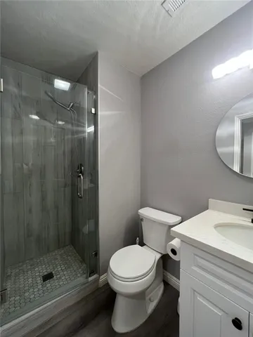 a bathroom with a toilet a sink and shower