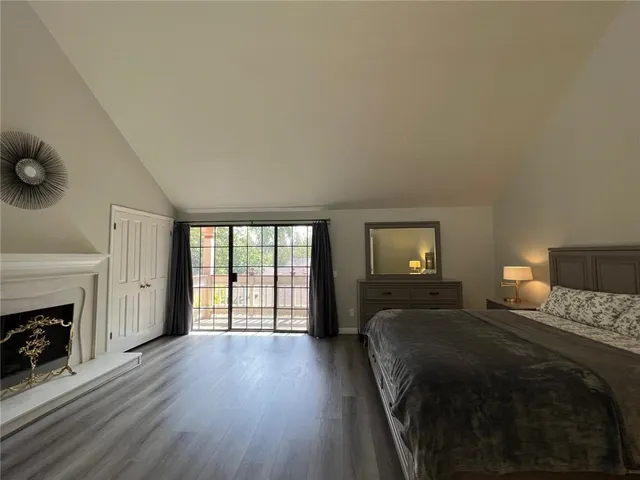 a bedroom with a bed and a fireplace