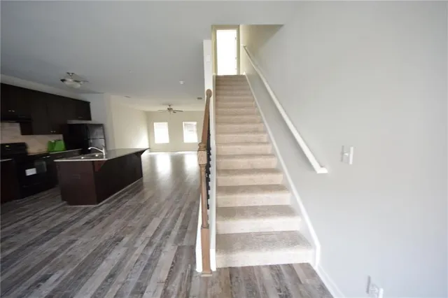 a view of a kitchen with wooden floor and cabinets