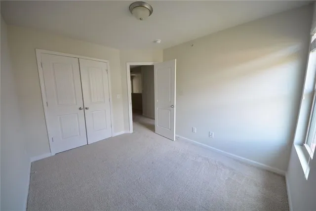 an empty room with closet area