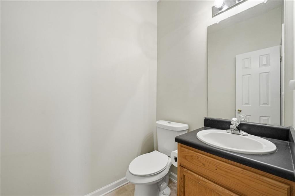 148 Timber Gate Drive Lawrenceville, GA 30045 - Photo 17 of 38 a bathroom with a granite countertop toilet and sink