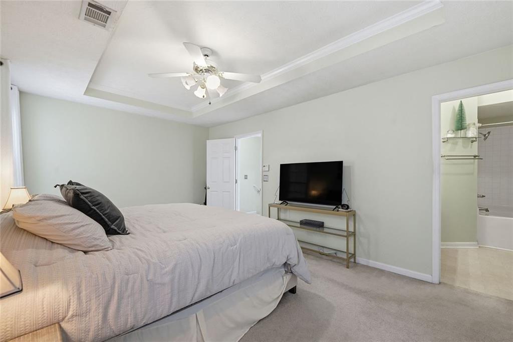 148 Timber Gate Drive Lawrenceville, GA 30045 - Photo 21 of 38 a bedroom with a bed window and a flat screen tv