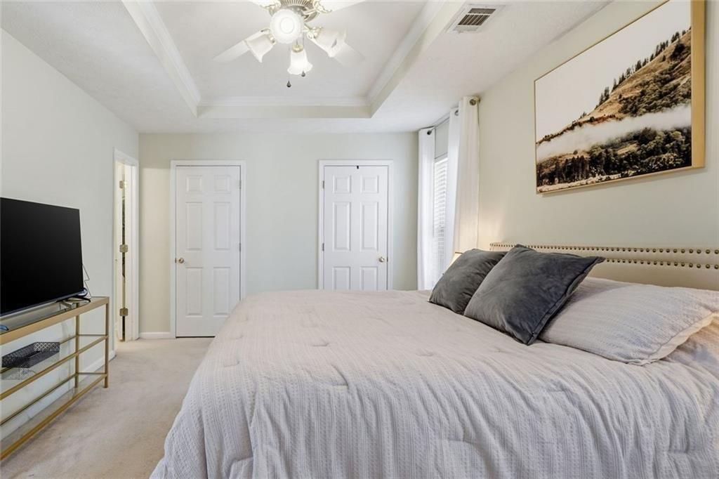 148 Timber Gate Drive Lawrenceville, GA 30045 - Photo 23 of 38 a bedroom with a bed tv and wooden floor