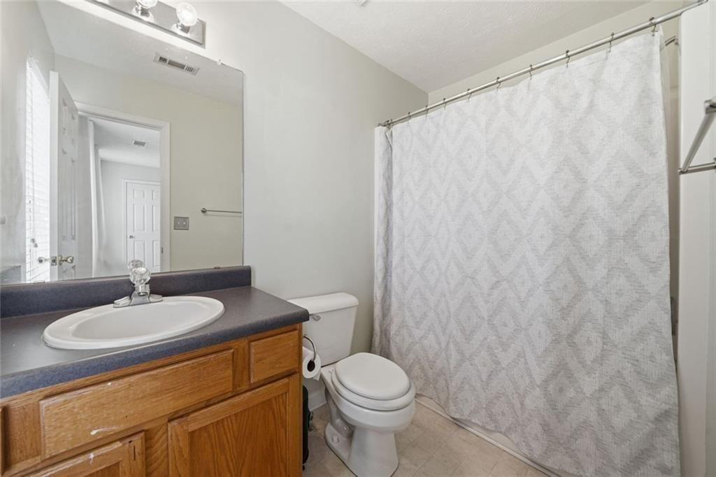 148 Timber Gate Drive Lawrenceville, GA 30045 - Photo 28 of 38 a bathroom with a sink toilet and a mirror