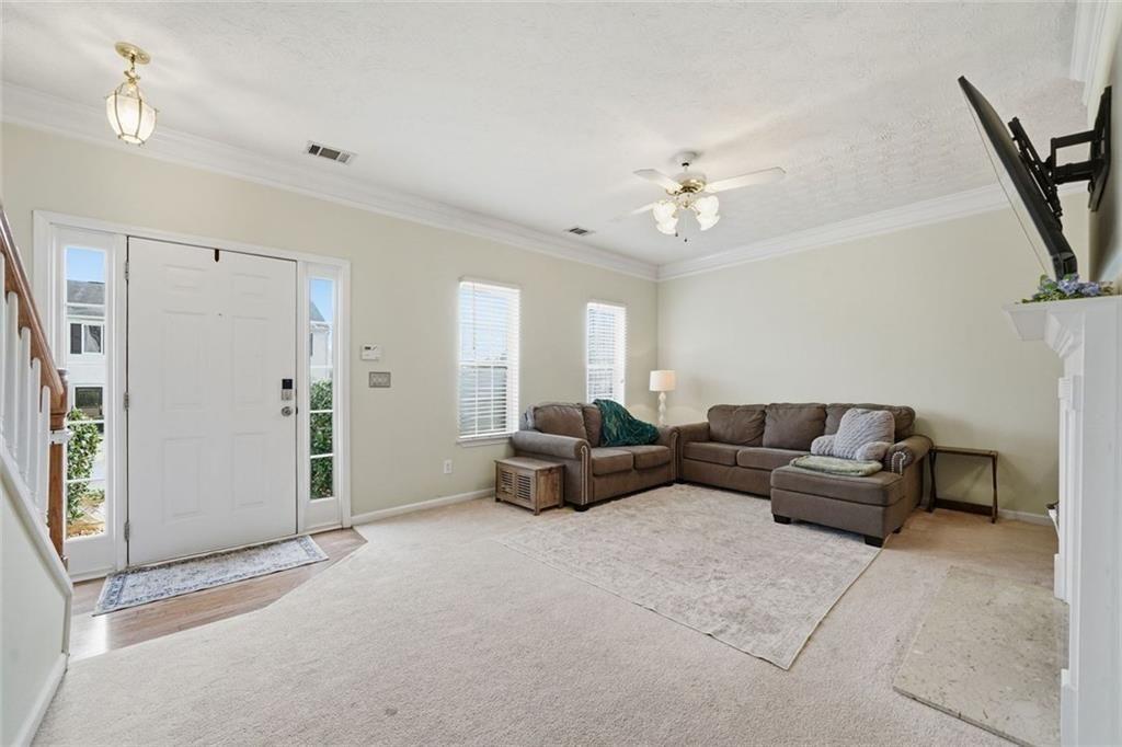 148 Timber Gate Drive Lawrenceville, GA 30045 - Photo 5 of 38 a living room with furniture and a chandelier