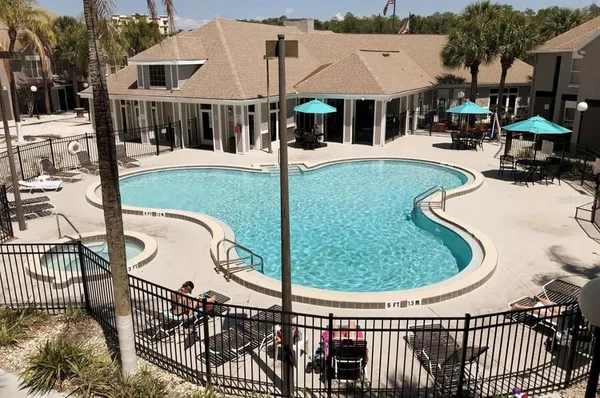 swimming pool view with a seating space and garden view