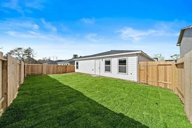 a view of a backyard with plants and a big yard
