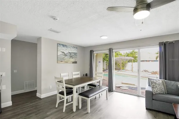 a workspace with furniture wooden floor and a chandelier fan