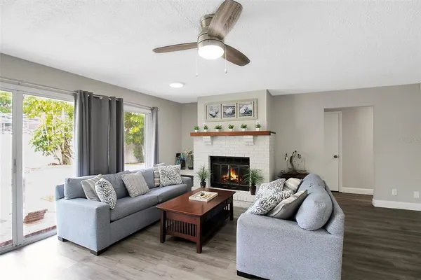 a living room with furniture and a fireplace