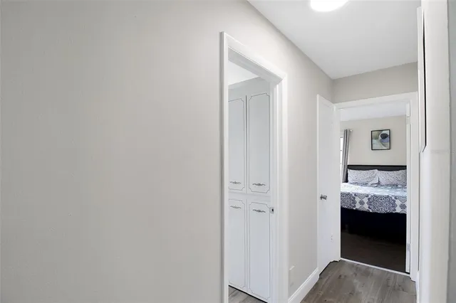 a view of a bedroom with wooden floor and cabinet