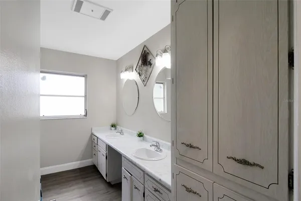 a spacious bathroom with a double vanity sink mirror and toilet