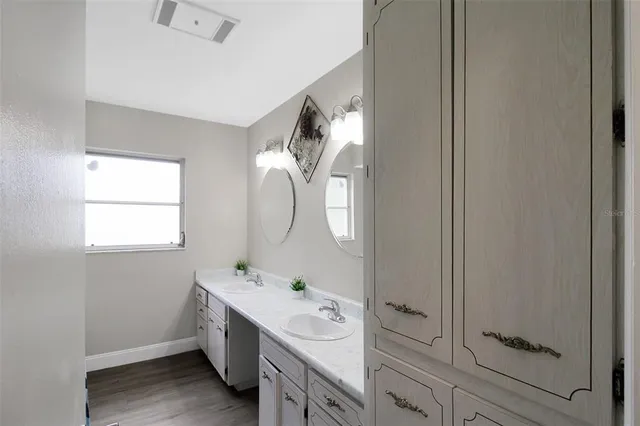 a spacious bathroom with a double vanity sink mirror and toilet