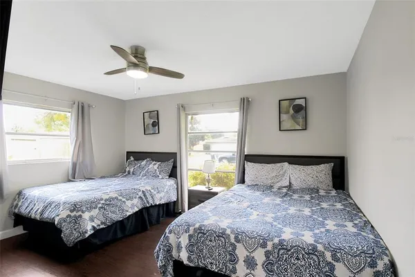 a bedroom with two beds and a window