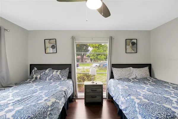 a bedroom with a large bed and a lamp on dresser