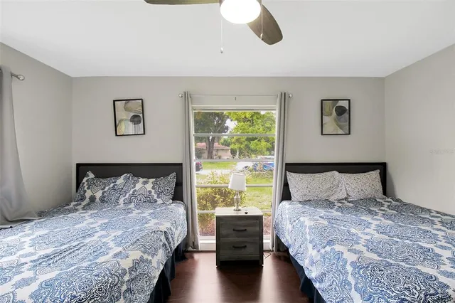 a bedroom with a large bed and a lamp on dresser