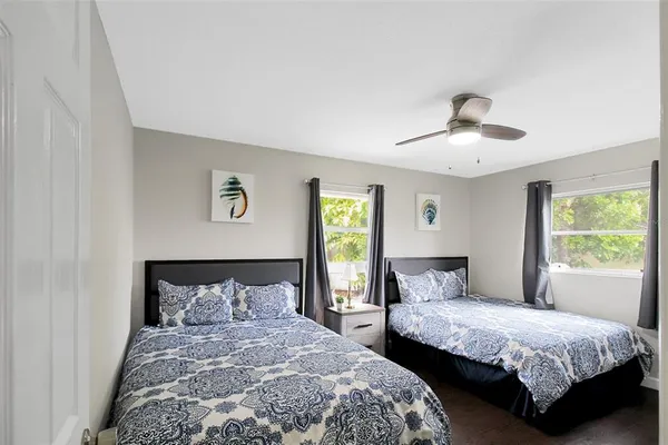 a bedroom with two beds and a window