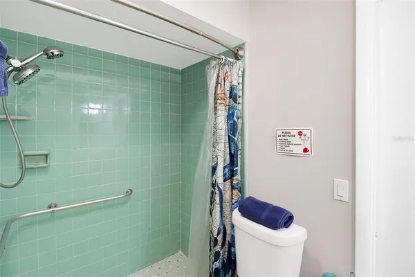 a bathroom with a toilet and shower