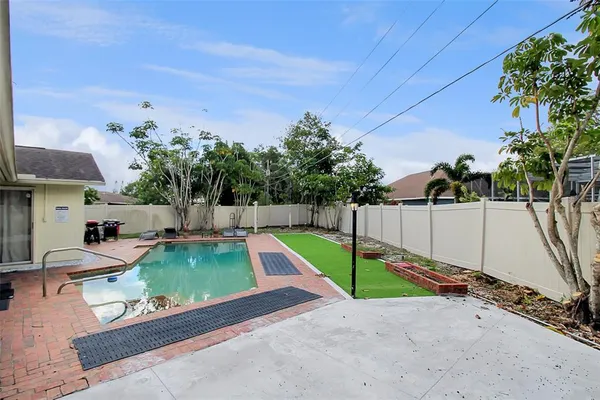 a view of a backyard with swimming pool