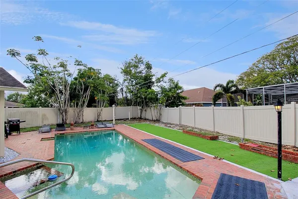 a view of a backyard with swimming pool
