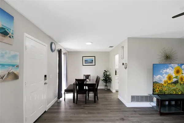 a view of a dining room with furniture and wooden floor