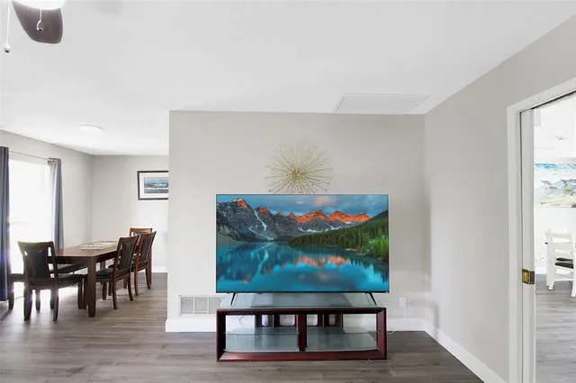 a living room with furniture a rug and a window