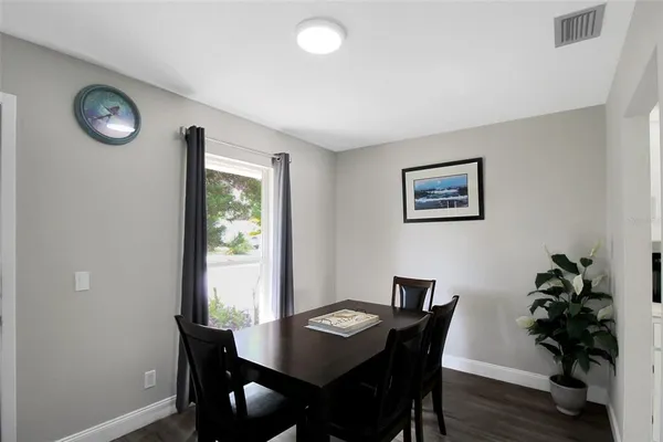 a view of a dining room with furniture window and wooden floor
