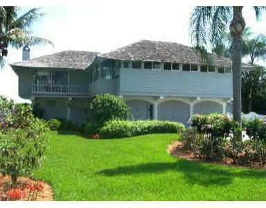 12 Island Road Sewall's Point, FL 34996 - Photo 1 of 1 a front view of a house with a garden