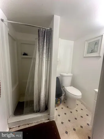 a bathroom with a toilet and a shower