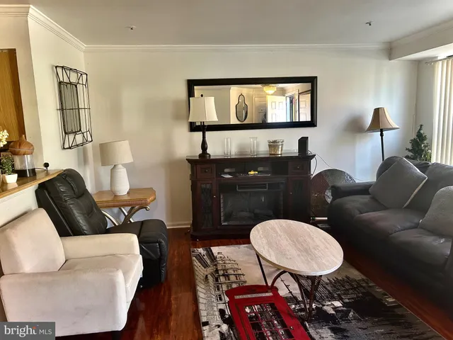a living room with furniture a table and painting on the wall