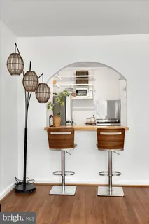 a living room with furniture a fireplace and a large window