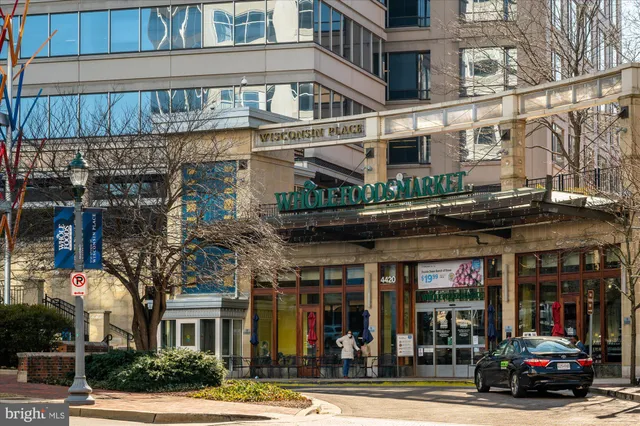 an aerial view of residential house with outdoor space and trees all around