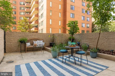 a backyard of a house with a couch and chairs