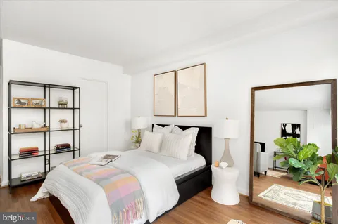 a bedroom with furniture a bed and a large window