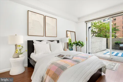 a bed sitting in a bedroom next to a window