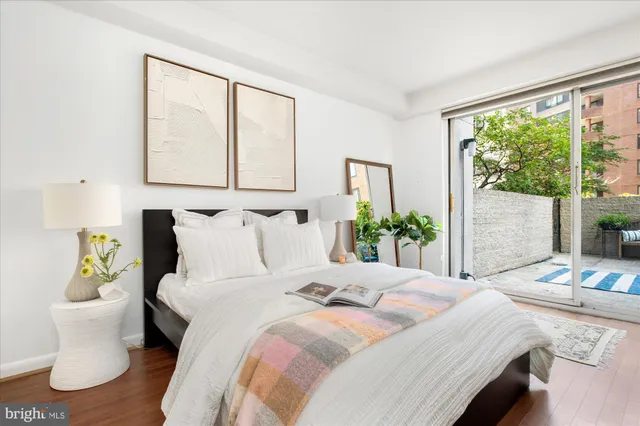 a bed sitting in a bedroom next to a window