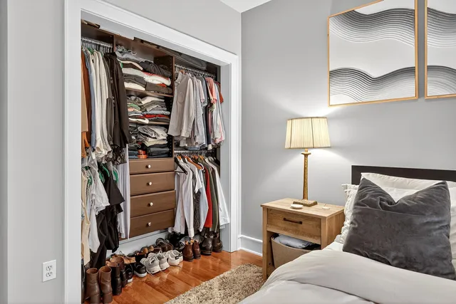 a bedroom with furniture a ceiling fan and a window