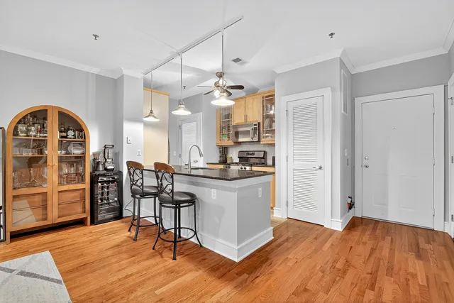 a view of a kitchen with dining space a sink and wooden floor