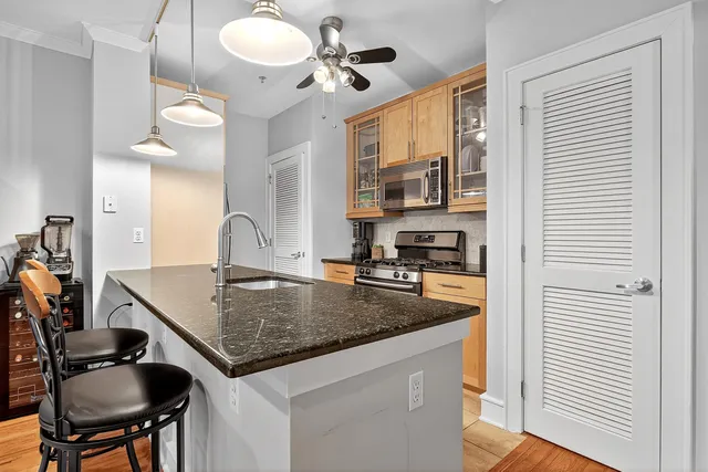 a kitchen with a table chairs and chandelier