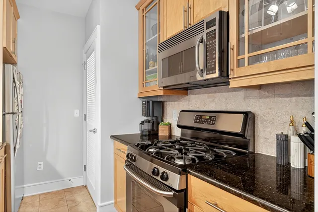 a kitchen with stainless steel appliances granite countertop a stove and a microwave