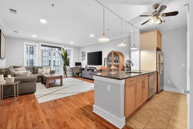 a view of living room with kitchen island furniture and a chandelier