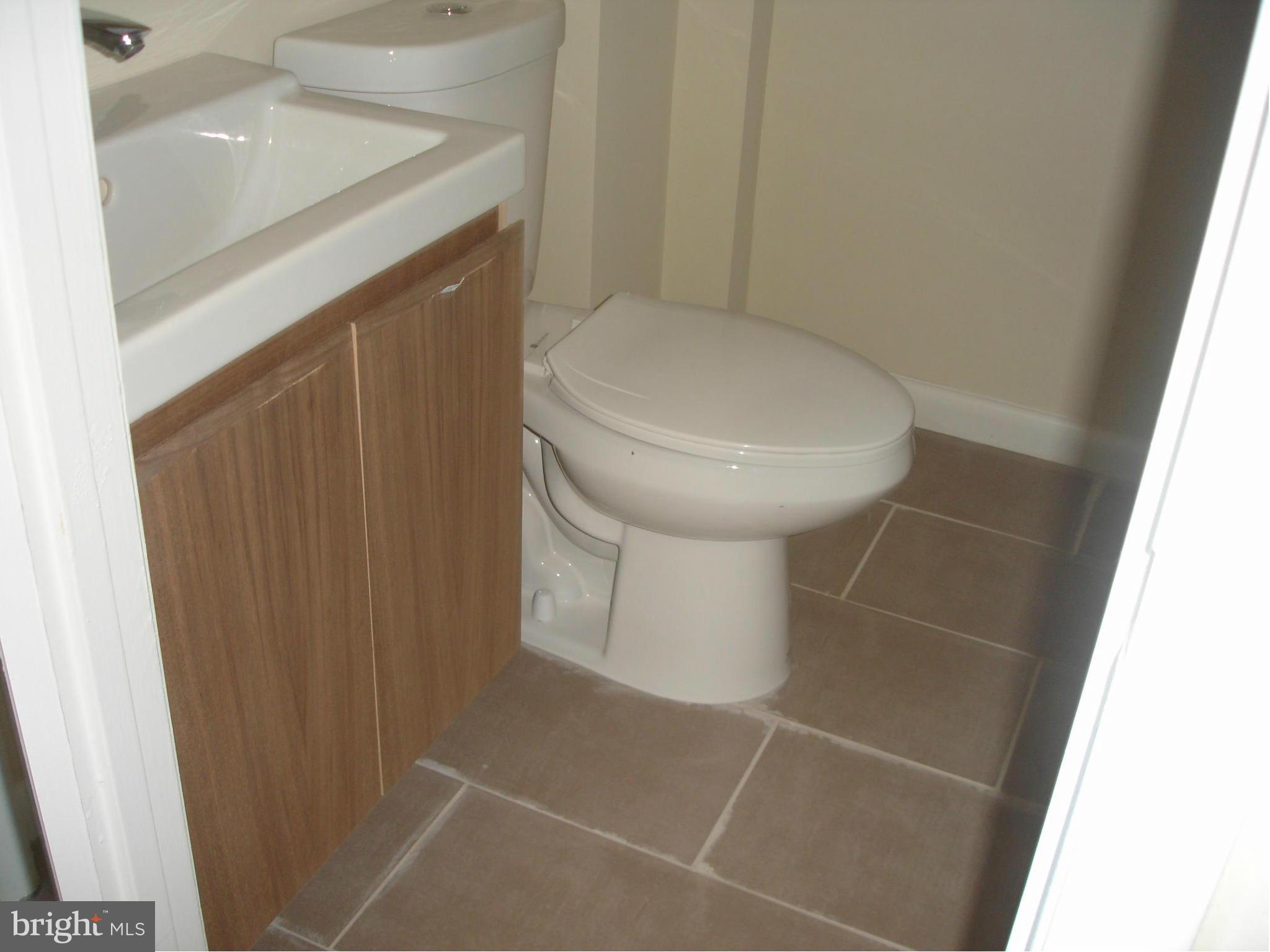 4705 Sargent Road Northeast Washington, DC 20017 - Photo 14 of 24 a bathroom with a toilet and a sink