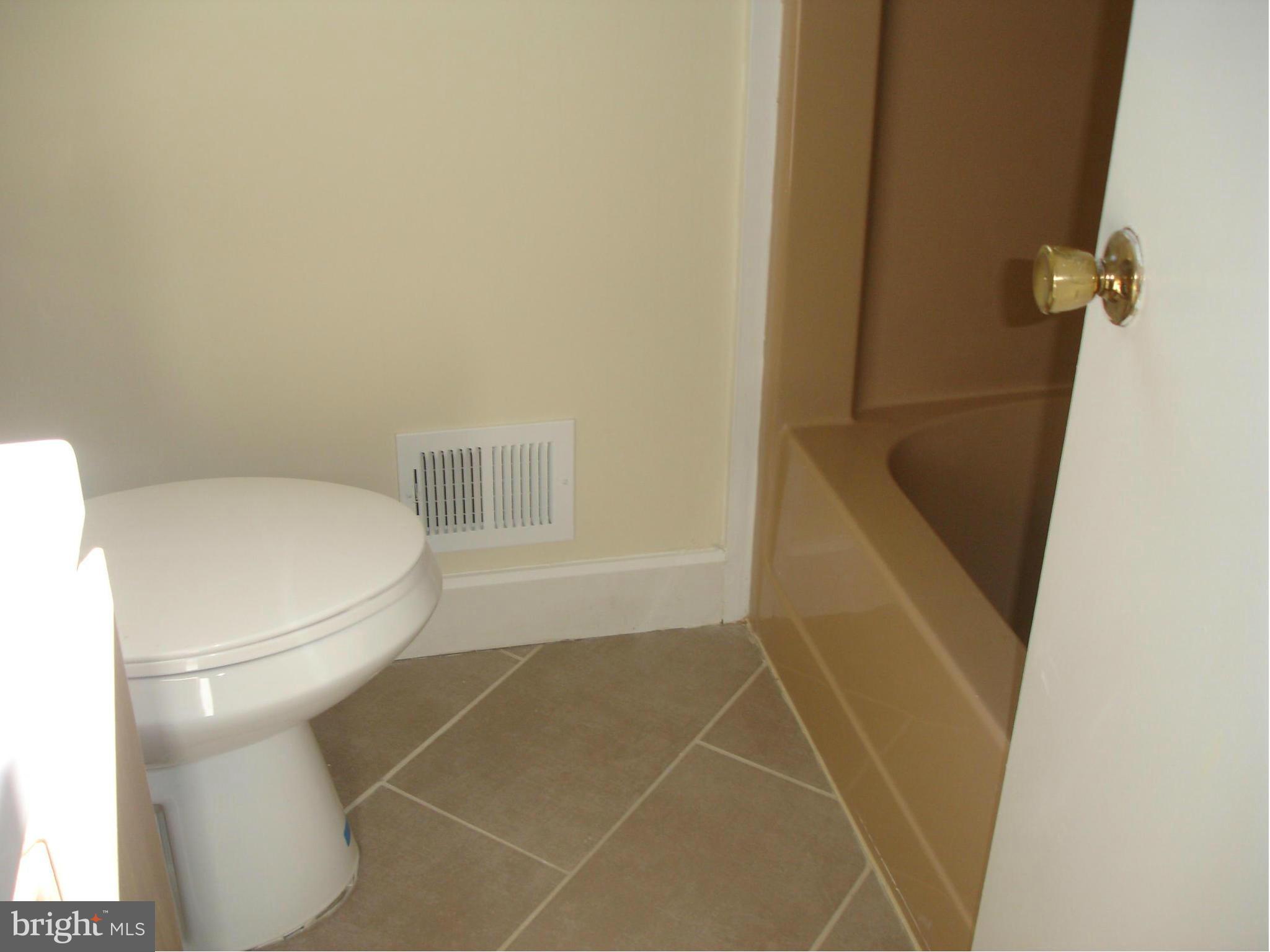 4705 Sargent Road Northeast Washington, DC 20017 - Photo 15 of 24 a bathroom with a toilet and a shower