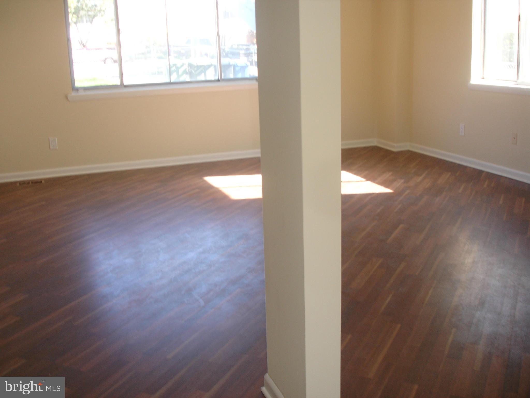 4705 Sargent Road Northeast Washington, DC 20017 - Photo 3 of 24 an empty room with wooden floor and windows