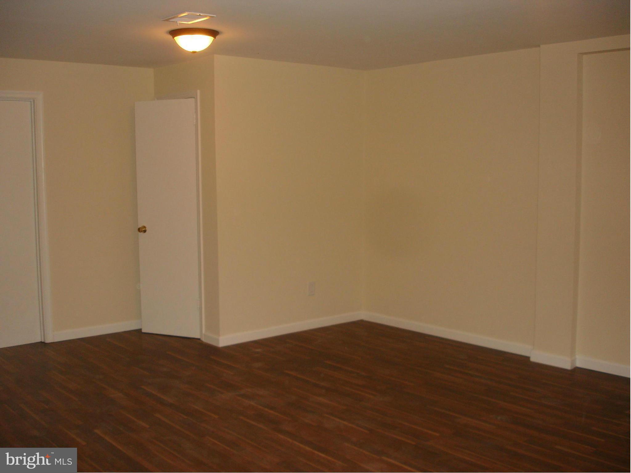 4705 Sargent Road Northeast Washington, DC 20017 - Photo 21 of 24 a view of an empty room with wooden floor