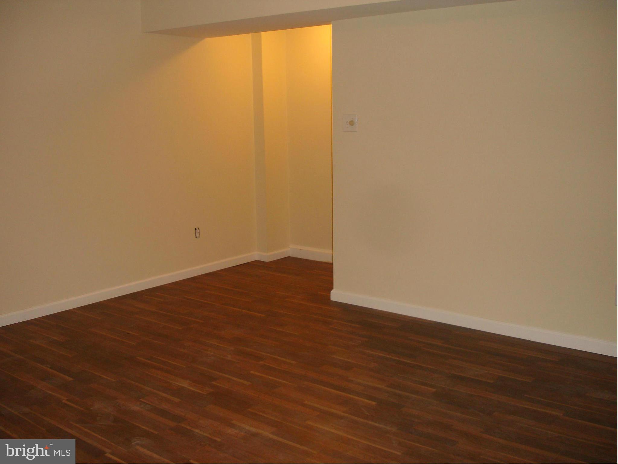 4705 Sargent Road Northeast Washington, DC 20017 - Photo 22 of 24 a view of an empty room with wooden floor and a window